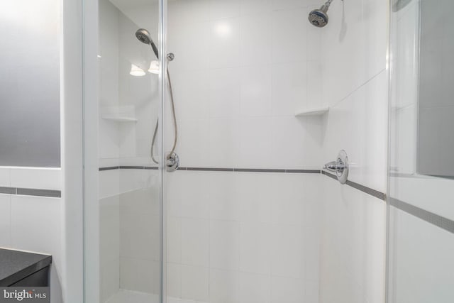 bathroom with a shower with shower door