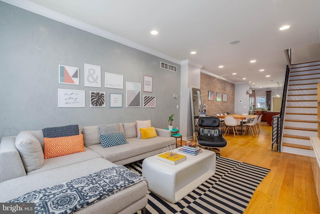 living room featuring ornamental molding and light wood-type flooring