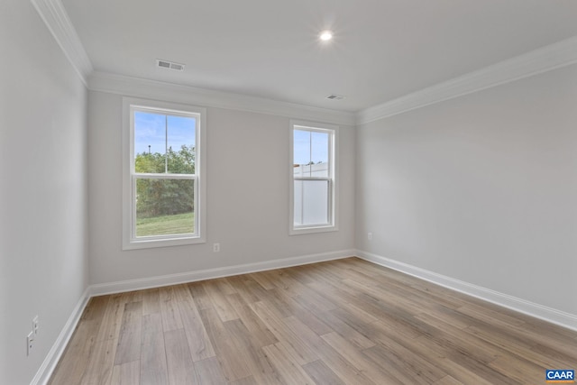 empty room with light hardwood / wood-style flooring and ornamental molding