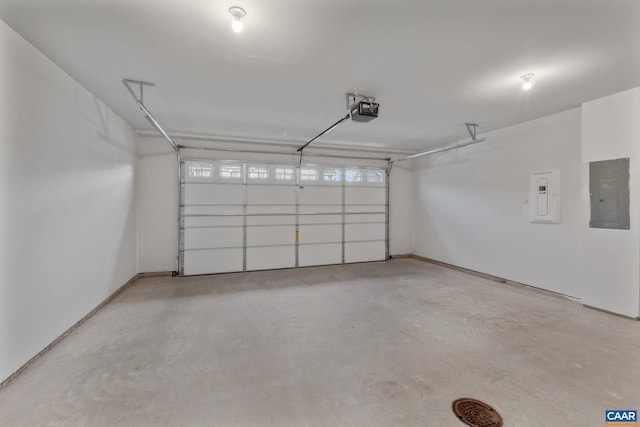 garage featuring electric panel and a garage door opener