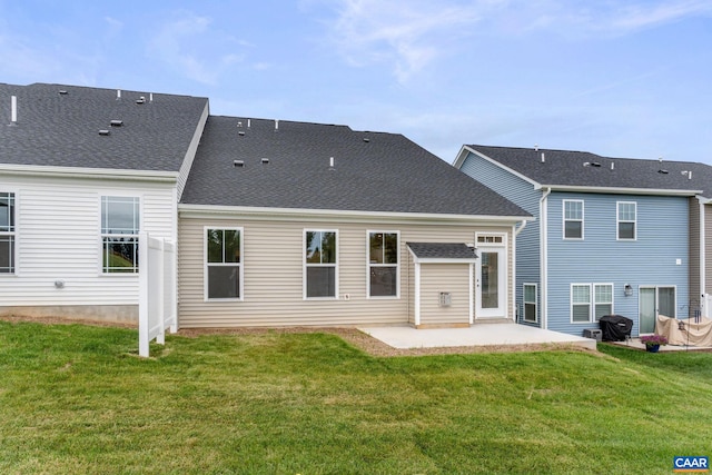 back of house with a patio and a lawn