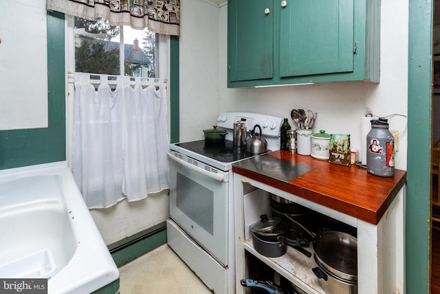 kitchen featuring green cabinetry, electric range, and wood counters