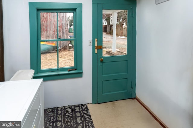 doorway featuring baseboards