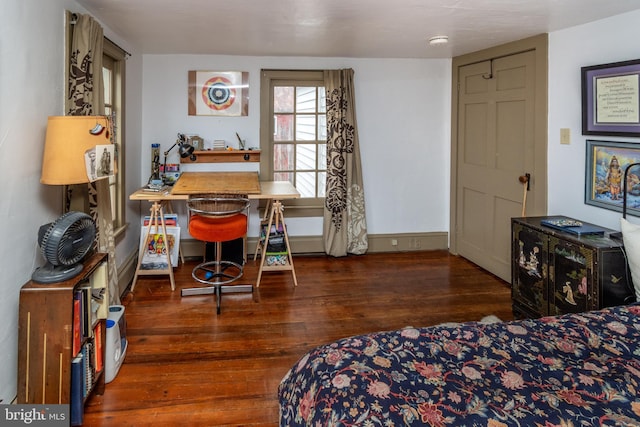 bedroom featuring baseboards and wood finished floors