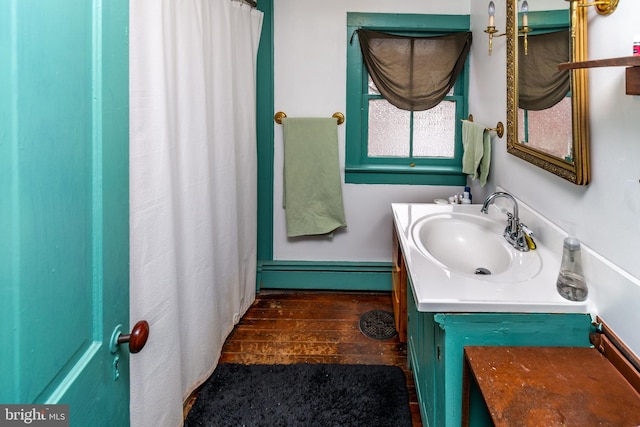 full bathroom with wood finished floors and vanity