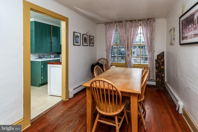 dining area with wood-type flooring and a baseboard radiator