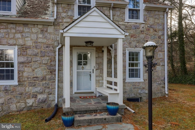 entrance to property featuring stone siding