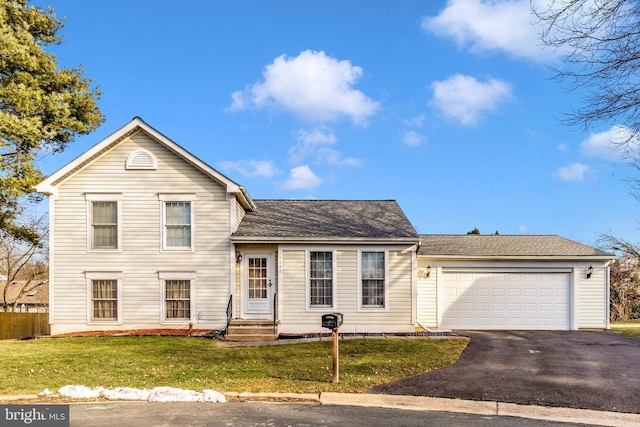 tri-level home featuring a garage, roof with shingles, a front yard, and entry steps