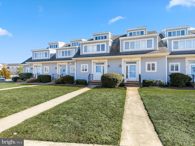 townhome / multi-family property featuring a front yard, a residential view, and entry steps