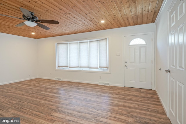 entrance foyer featuring hardwood / wood-style floors, wooden ceiling, and a wealth of natural light