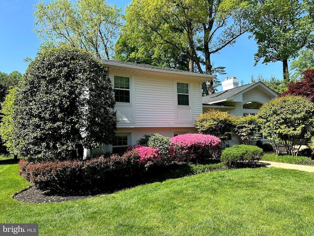 view of side of property with a yard