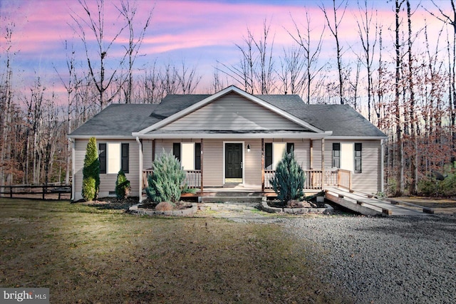 view of front of house with a yard and a porch