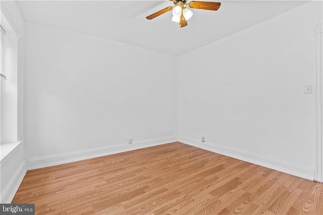 empty room featuring light wood-type flooring and baseboards