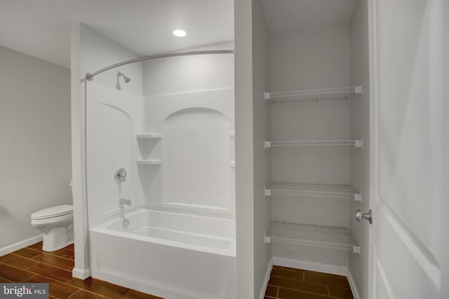 bathroom featuring toilet and tub / shower combination