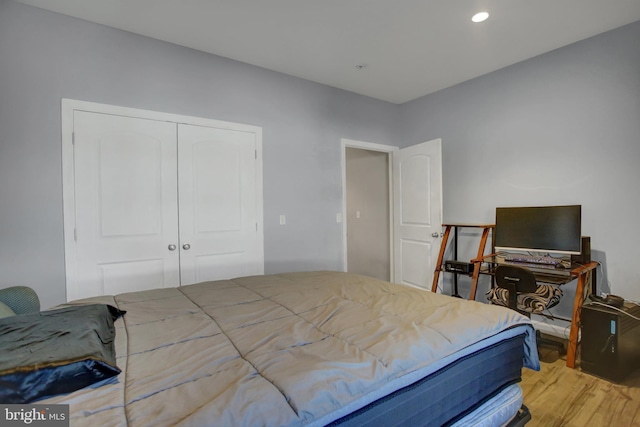 bedroom with hardwood / wood-style flooring and a closet