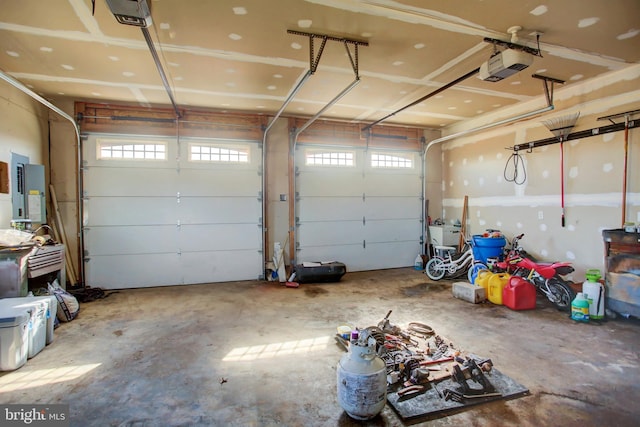 garage featuring electric panel and a garage door opener