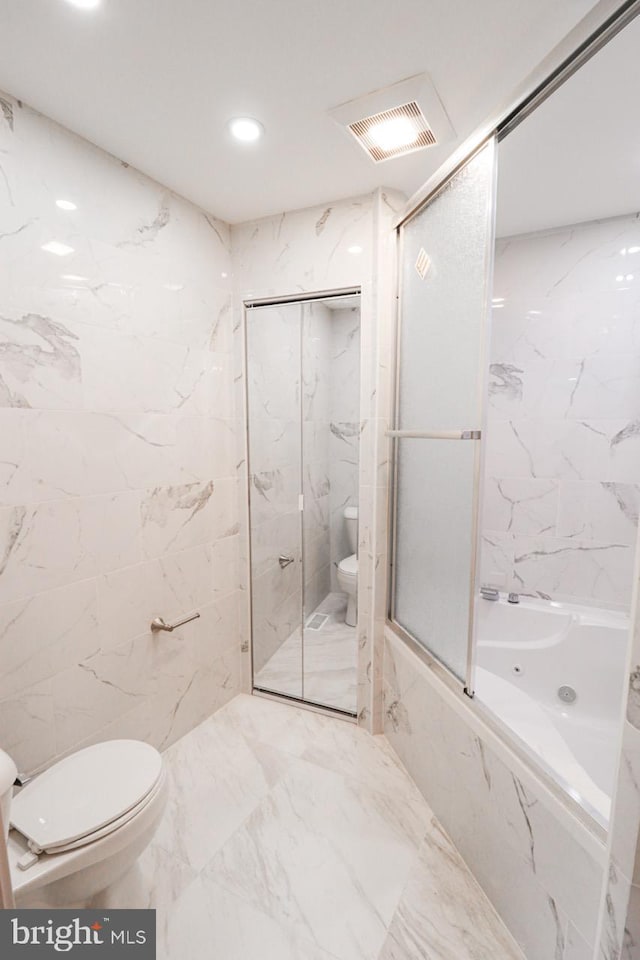 full bath with visible vents, a combined bath / shower with marble appearance, toilet, marble finish floor, and tile walls