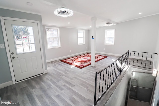 entrance foyer featuring baseboards, stairway, ornamental molding, wood finished floors, and recessed lighting