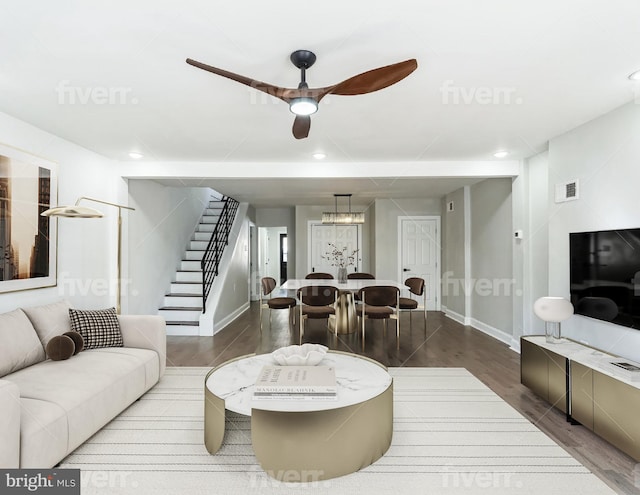 living room featuring hardwood / wood-style flooring and ceiling fan