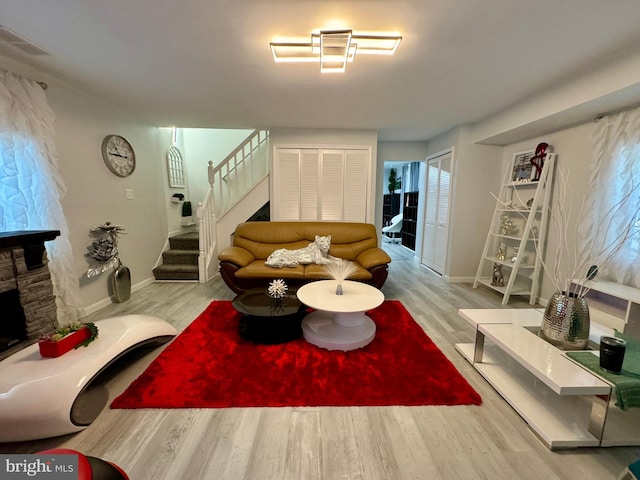 living room featuring light hardwood / wood-style floors and a fireplace