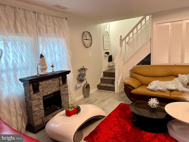 living room with light wood-type flooring and a fireplace