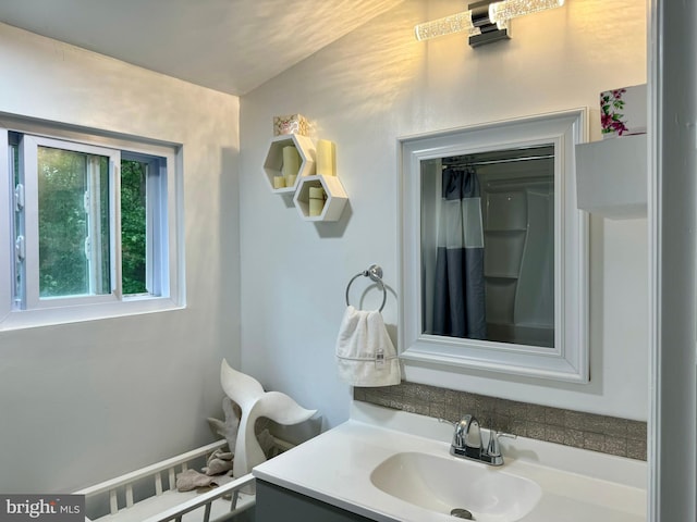 bathroom with vanity and vaulted ceiling