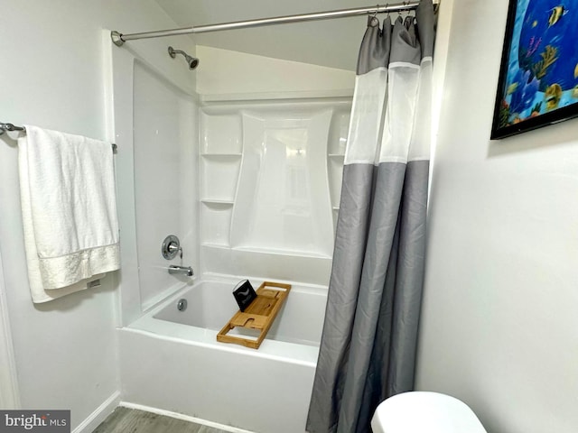 bathroom with toilet, shower / bath combo, and hardwood / wood-style floors