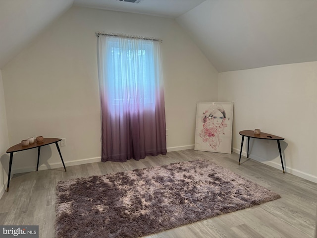 bonus room with lofted ceiling and hardwood / wood-style floors