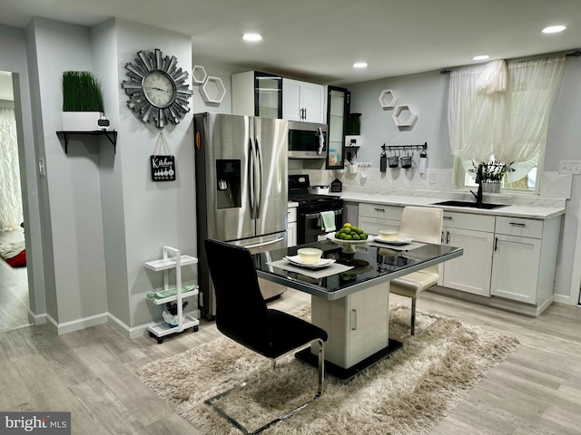 interior space with sink and light hardwood / wood-style floors