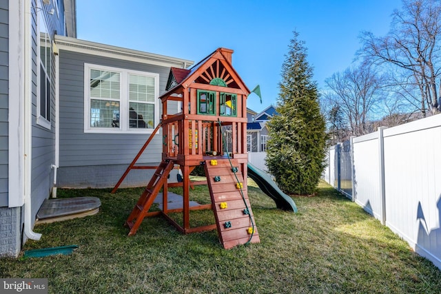 view of play area featuring a yard and fence