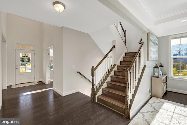 entrance foyer featuring crown molding, stairs, baseboards, and wood finished floors