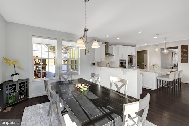 dining room with baseboards, dark wood-type flooring, and recessed lighting