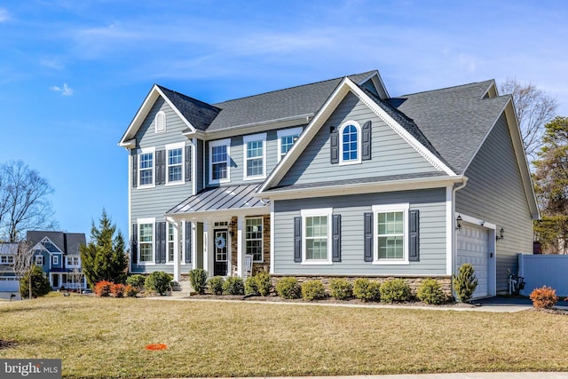 view of front of home with covered porch, a front yard, a standing seam roof, metal roof, and a garage