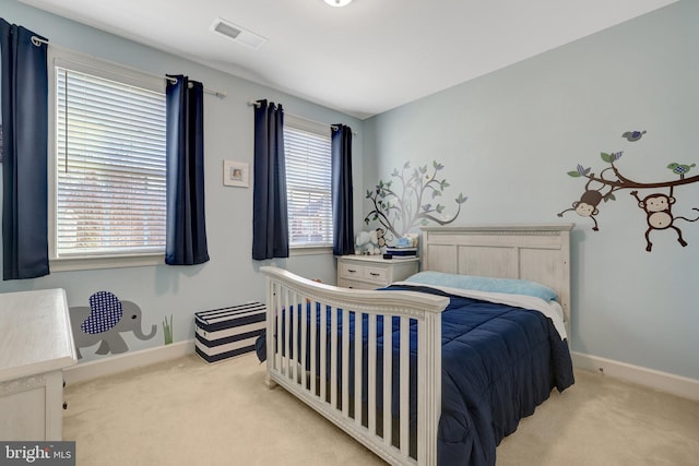 carpeted bedroom featuring visible vents and baseboards