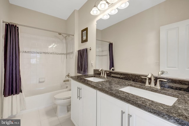 bathroom featuring tile patterned flooring, a sink, shower / tub combo, and toilet