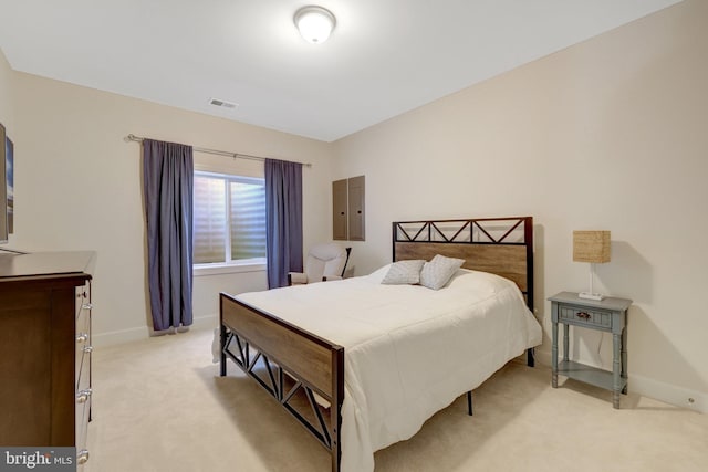 bedroom with light carpet, visible vents, and baseboards