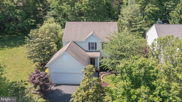 view of front of house with a garage, a shingled roof, and aphalt driveway