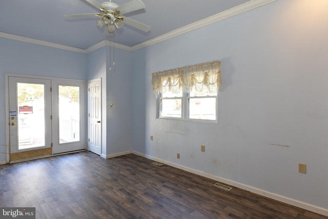 empty room with plenty of natural light, dark wood-type flooring, and crown molding