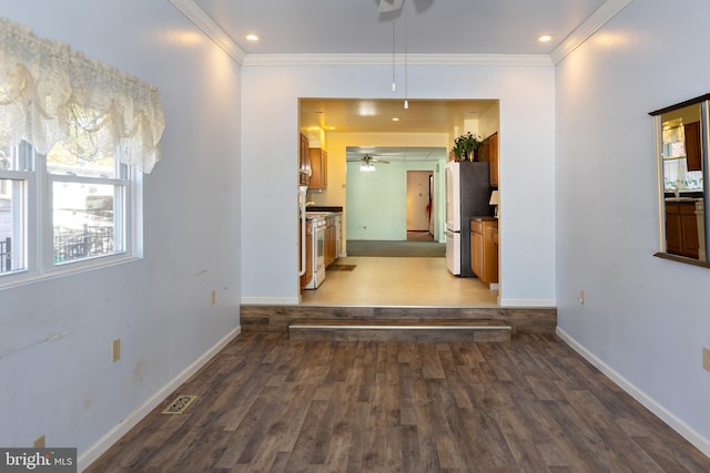 hallway featuring hardwood / wood-style flooring and ornamental molding