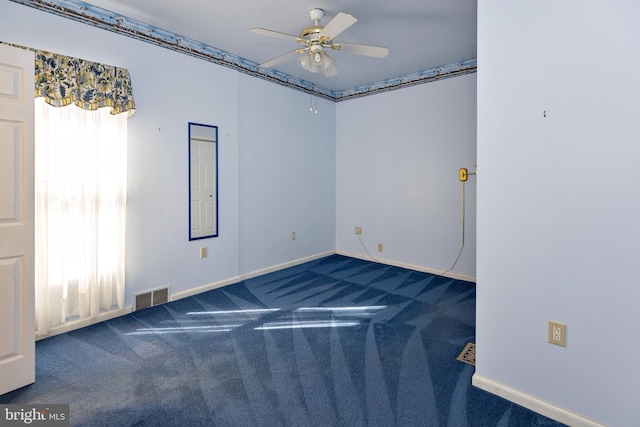 carpeted spare room with ceiling fan