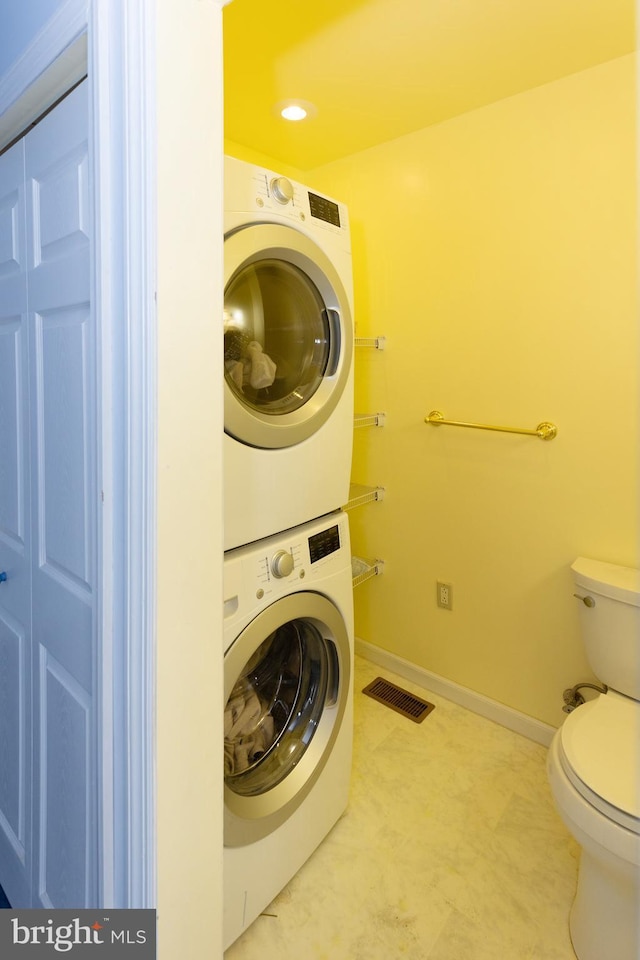 laundry room featuring stacked washer and dryer