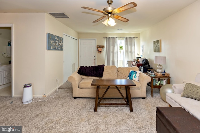 carpeted living room featuring ceiling fan