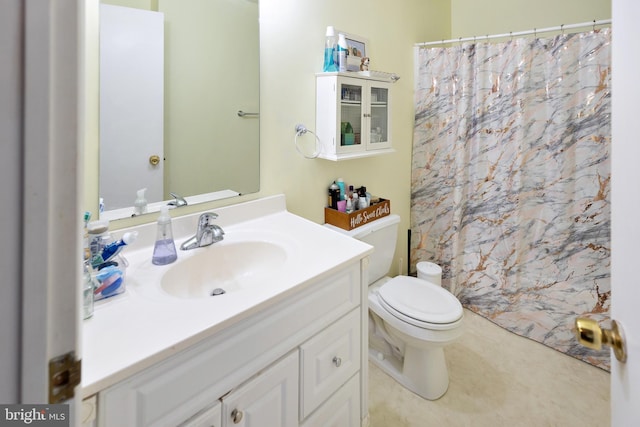 bathroom featuring toilet and vanity