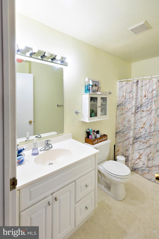 bathroom with vanity, toilet, and walk in shower