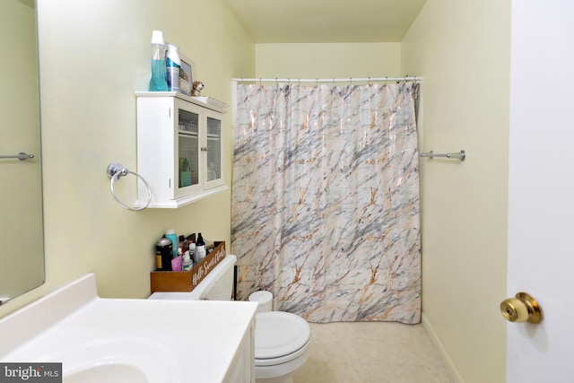 bathroom with toilet, vanity, and a shower with shower curtain