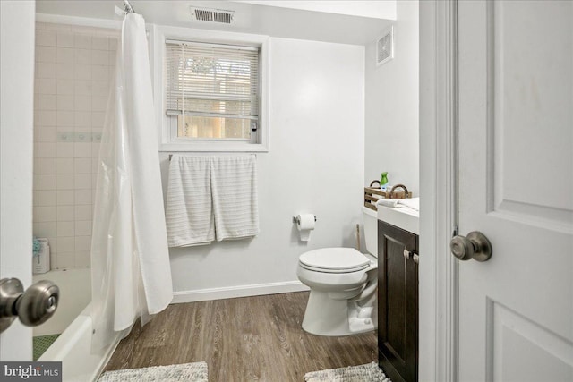 full bathroom featuring shower / bath combination with curtain, vanity, toilet, and hardwood / wood-style floors