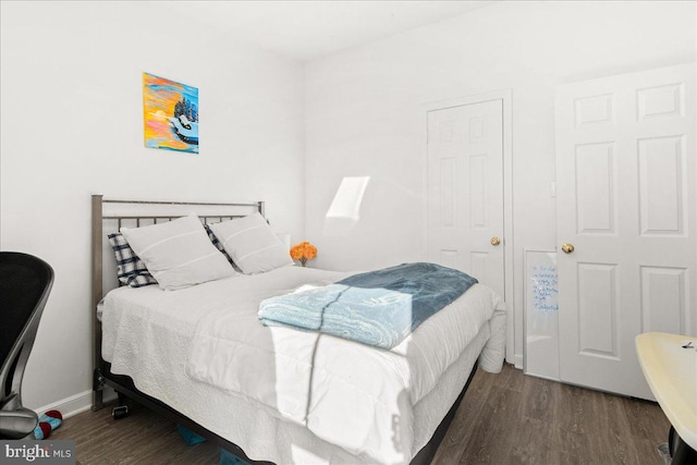 bedroom with dark hardwood / wood-style floors