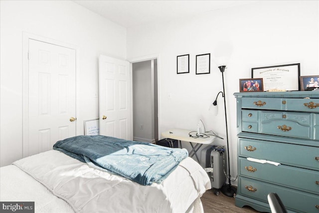 bedroom with dark wood-type flooring