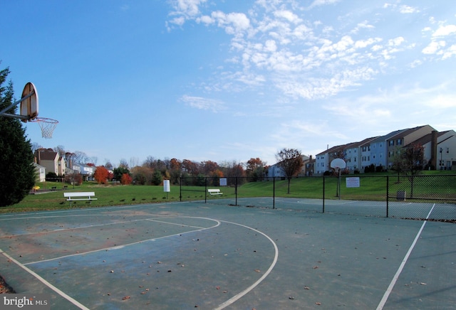 view of basketball court featuring a lawn