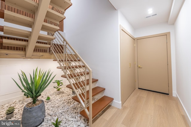 217 Tasker St, Philadelphia, PA 19148 - staircase with wood finished floors, visible vents, and baseboards